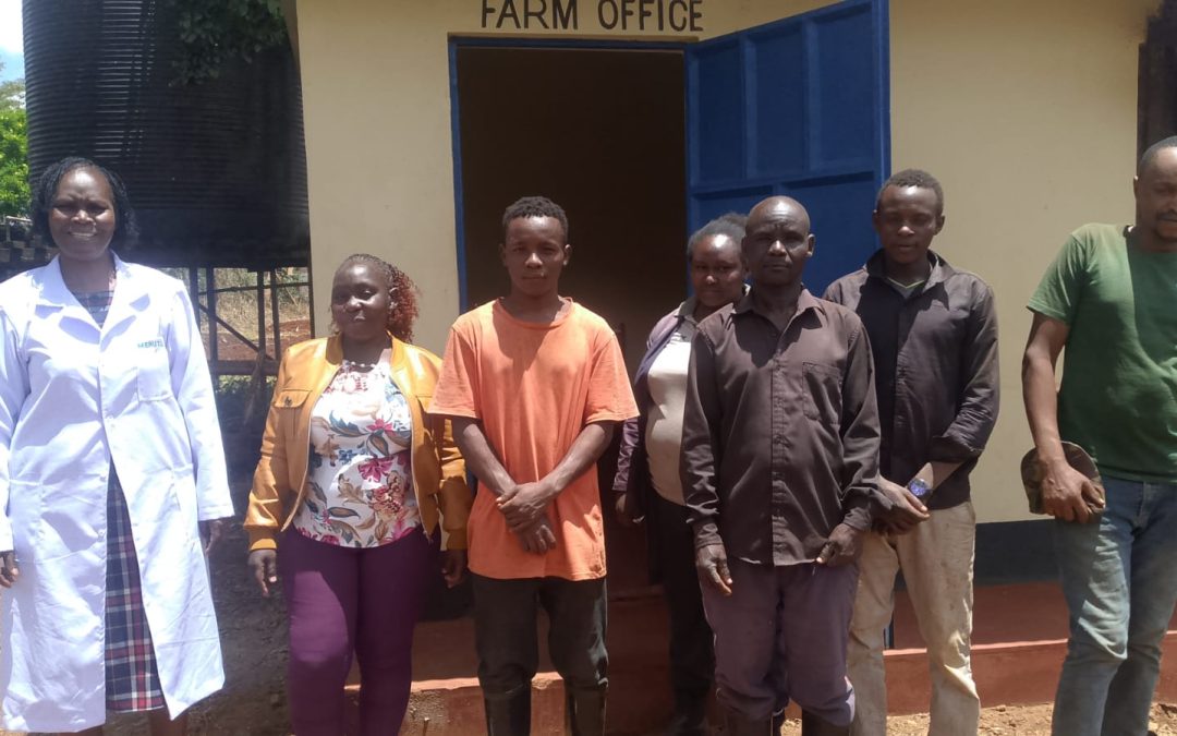 The College Chaplain poses with farm staff outside the newly opened Farm Office during the official blessing and commissioning ceremony at Meru Teachers Training College.